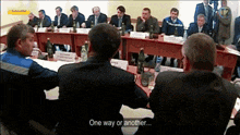 a group of men are sitting around a table with the words one way or another on the bottom