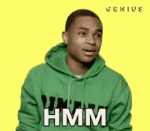 a young man in a green hoodie is making a funny face and saying `` hmm '' .