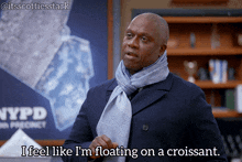 a man wearing a scarf says i feel like i m floating on a croissant