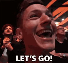 a man is laughing with the words let 's go in white letters