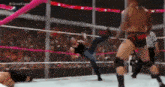 a wrestler is kicking another wrestler in the face during a match in a wrestling ring .