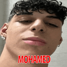 a close up of a young man 's face with the name mohamed above him