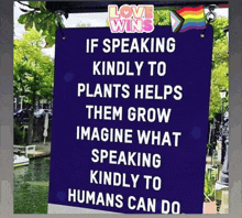 a purple sign says if speaking kindly to plants helps them grow imagine what speaking kindly to humans can do