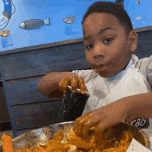 Kid Eating Kid Drinking In Black Cup GIF - Kid Eating Kid Drinking In Black Cup Boy Rolls His Eyes When Drinking And Eatting Corn GIFs