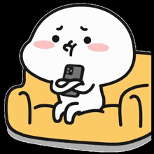 a cartoon character is sitting on a yellow couch holding a cell phone in his hand .