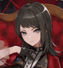 a girl with black hair and blue eyes is sitting in a chair