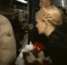 a blurred image of a woman holding a red heart