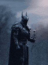 a black knight holding a rose in his hand
