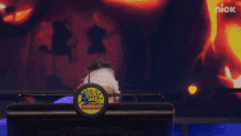 a woman in a mummy costume behind a podium that says nick