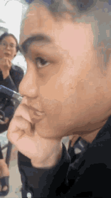a close up of a person 's face with a pen on it
