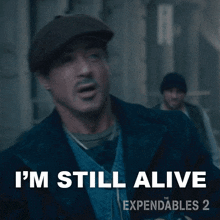 I'M Still Alive Barney Ross GIF - I'M Still Alive Barney Ross Sylvester Stallone GIFs