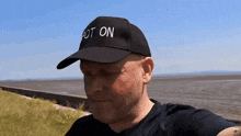 a man is wearing a hat that says got on
