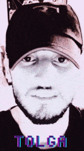 a man wearing a hat with the word tolga written on it