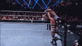 two wrestlers are in a wrestling ring with a w logo on the wall behind them