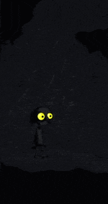 a cartoon character with yellow eyes is standing on a cliff in the dark .
