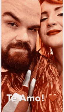 a man with a beard and a woman with red hair are standing next to each other with the words te amo written above them