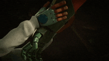 a close up of a person 's hand wearing a glove