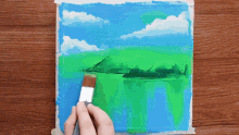 a person is using a brush to paint a painting of a lake