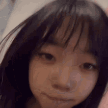 a close up of a young girl 's face with a hoodie on .