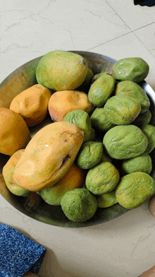 a bowl filled with green and yellow fruits