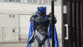 a person in a robot costume is standing in front of a fence