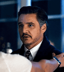 a man with a beard and mustache in a suit and tie