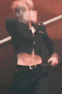 a man is dancing in front of a red background with the words let the chaos begin above him .