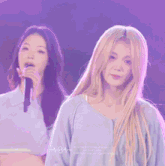 a woman with long blonde hair is wearing a blue shirt with the word heartbeat on it