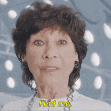 an older woman says find me in yellow letters on her face