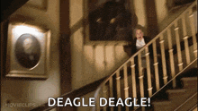 a man is walking down a set of stairs with the words deagle deagle written on the bottom of the screen .