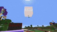 a large tnt sign is flying in the sky above a minecraft world
