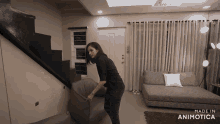 a woman in a living room with the words made in animotica on the bottom right