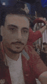 a man with a beard is taking a selfie with a popcut watermark on the bottom right