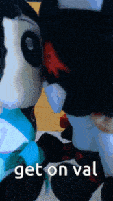 two stuffed animals are kissing with the words get on val written below them