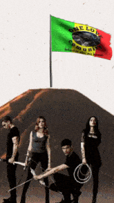 a group of people standing under a flag that says one love community