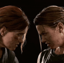 two women looking at each other with their faces covered in sweat
