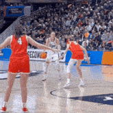 a basketball game is being played in front of a march madness banner