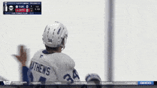 a hockey player named matthews is wearing a white oreo helmet