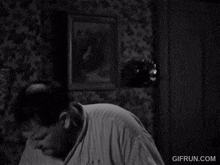 a black and white photo of a man with the website gifrun.com in the bottom right corner