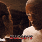 a man and a woman are looking at each other with nobody 's written in red letters