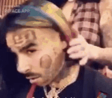 a man with a bandana on his head is getting his hair cut by a woman .