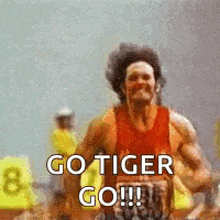 a man is running on a track with the words `` go tiger go '' written on it .