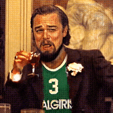 a man with a beard wearing a green algiris jersey