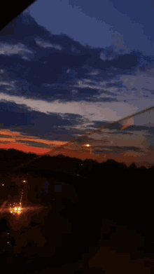 a blurry picture of a sunset over a highway with cars driving by