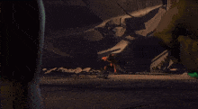 a man in a red suit is crawling on the ground in a dark room