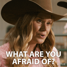 a woman in a cowboy hat says what are you afraid of netflix