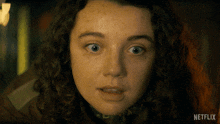 a close up of a woman 's face with a netflix logo on the bottom