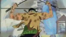 a man in a yellow shirt is holding two swords in his hands .