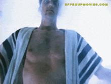 a shirtless man is standing in front of a screen that says " effectupmovies.com "