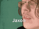 a close up of a person 's face with the name jaxon written in white